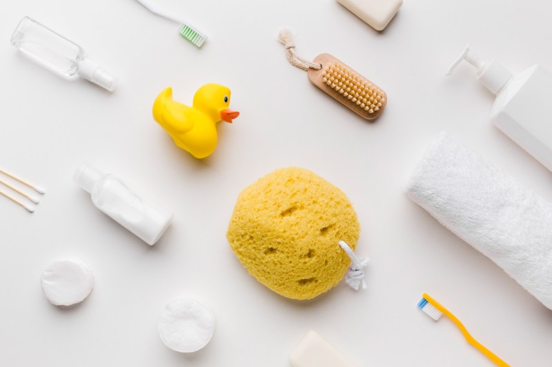 Arrangement of hypoallergenic baby care bottles, washes, and soothing balms